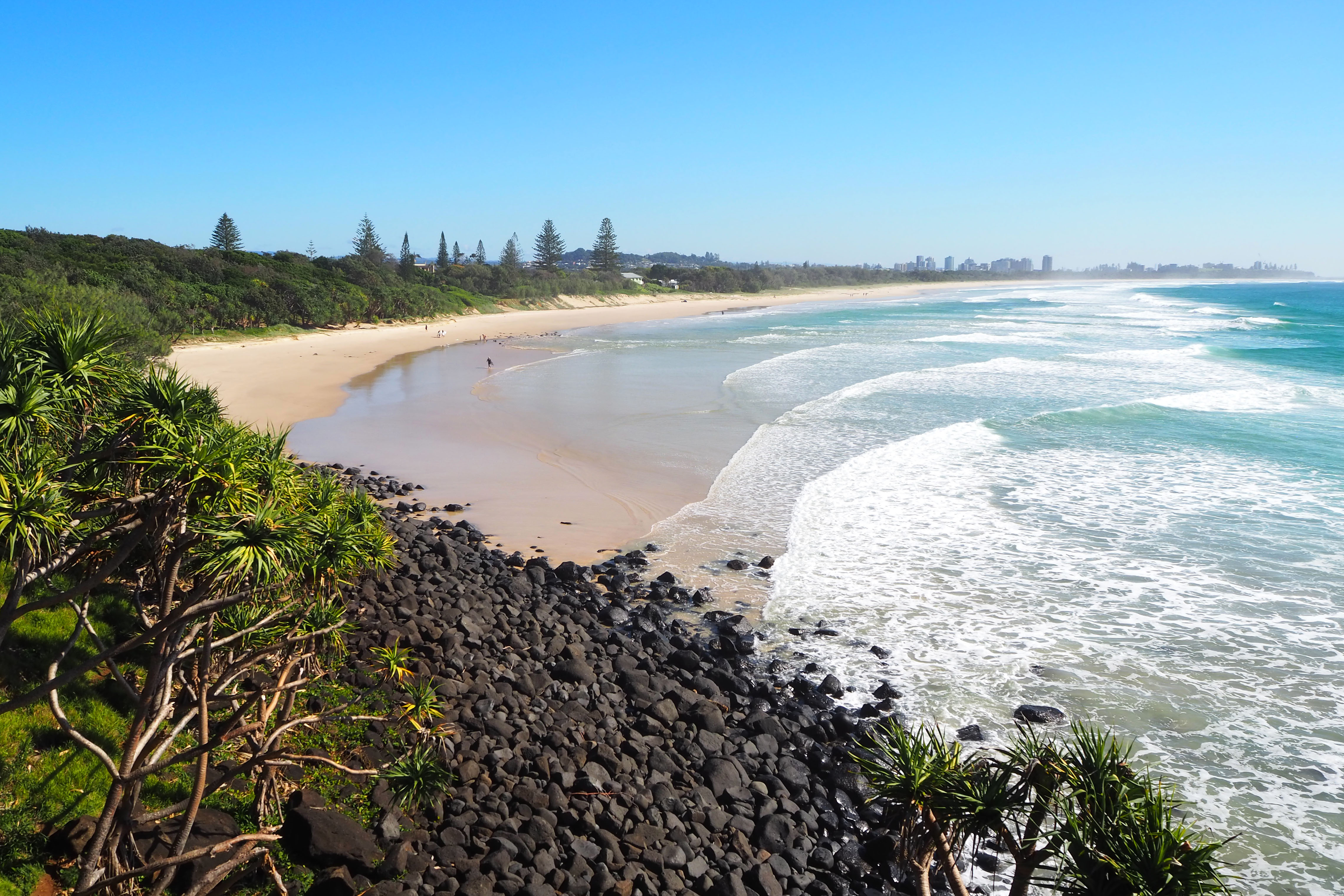 Black boulders and pandanus palms mark the southern end of Fingal Beach